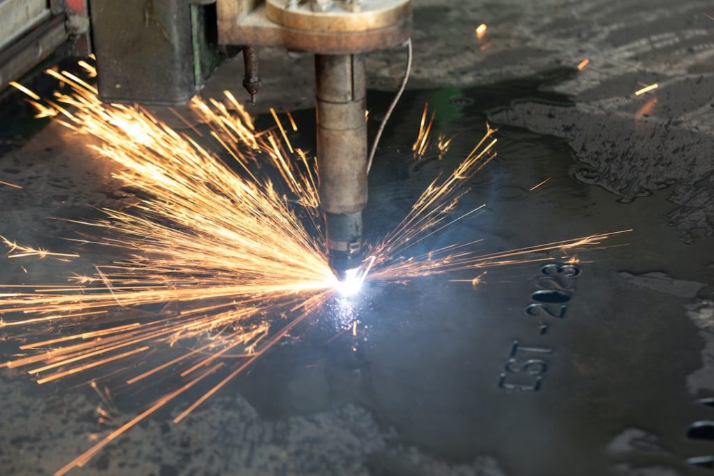 a-welder-cutting-a-piece-of-metal-with-sparks-py-waelf5fs a-welder-cutting-a-piece-of-metal-with-sparks-py-waelf5fs